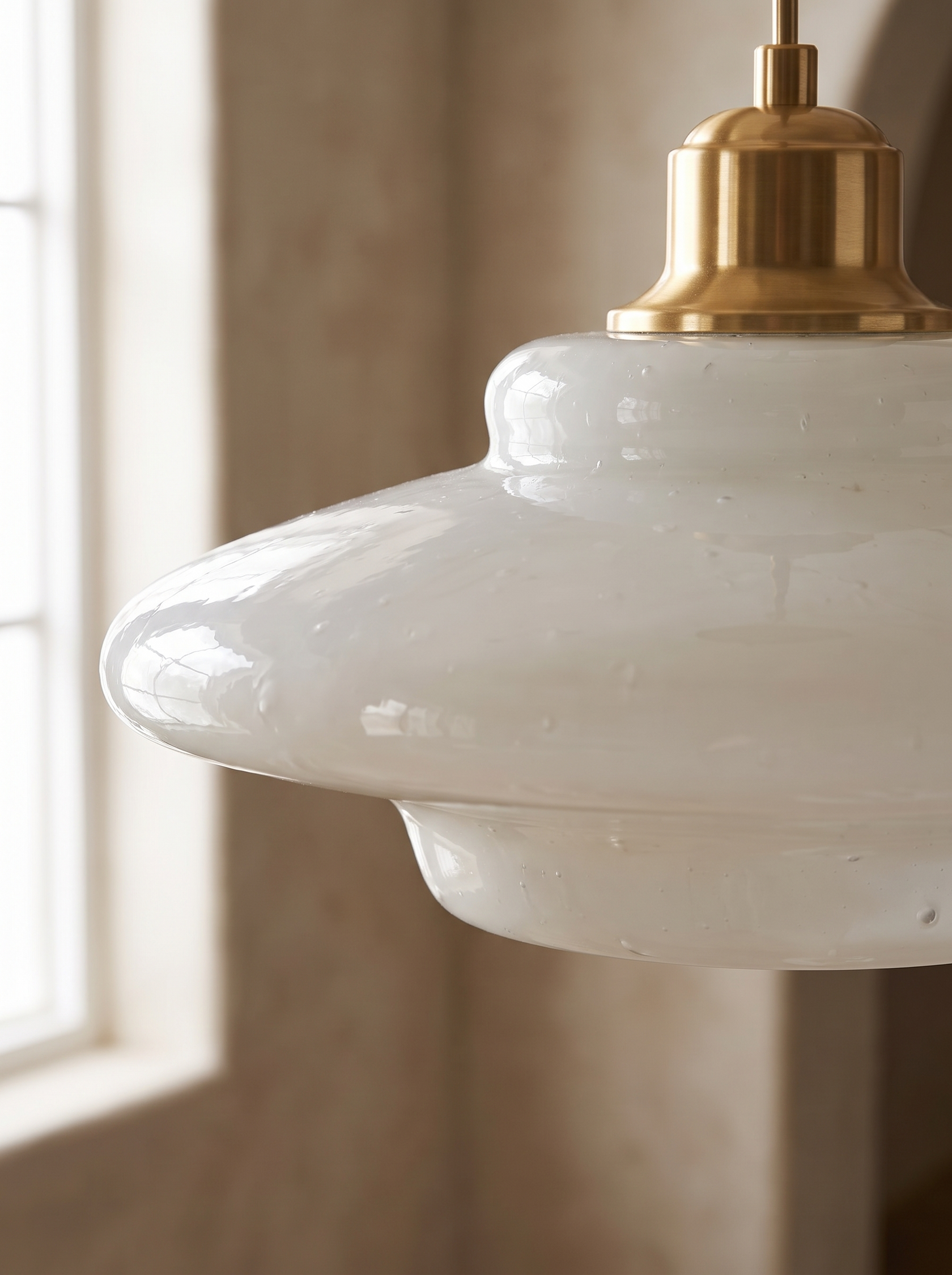 Lattea pendant unlit showing hand blown glass variation and the brass collar