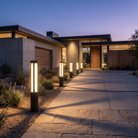 Aurelia Bollard Path Light along a driveway at dusk