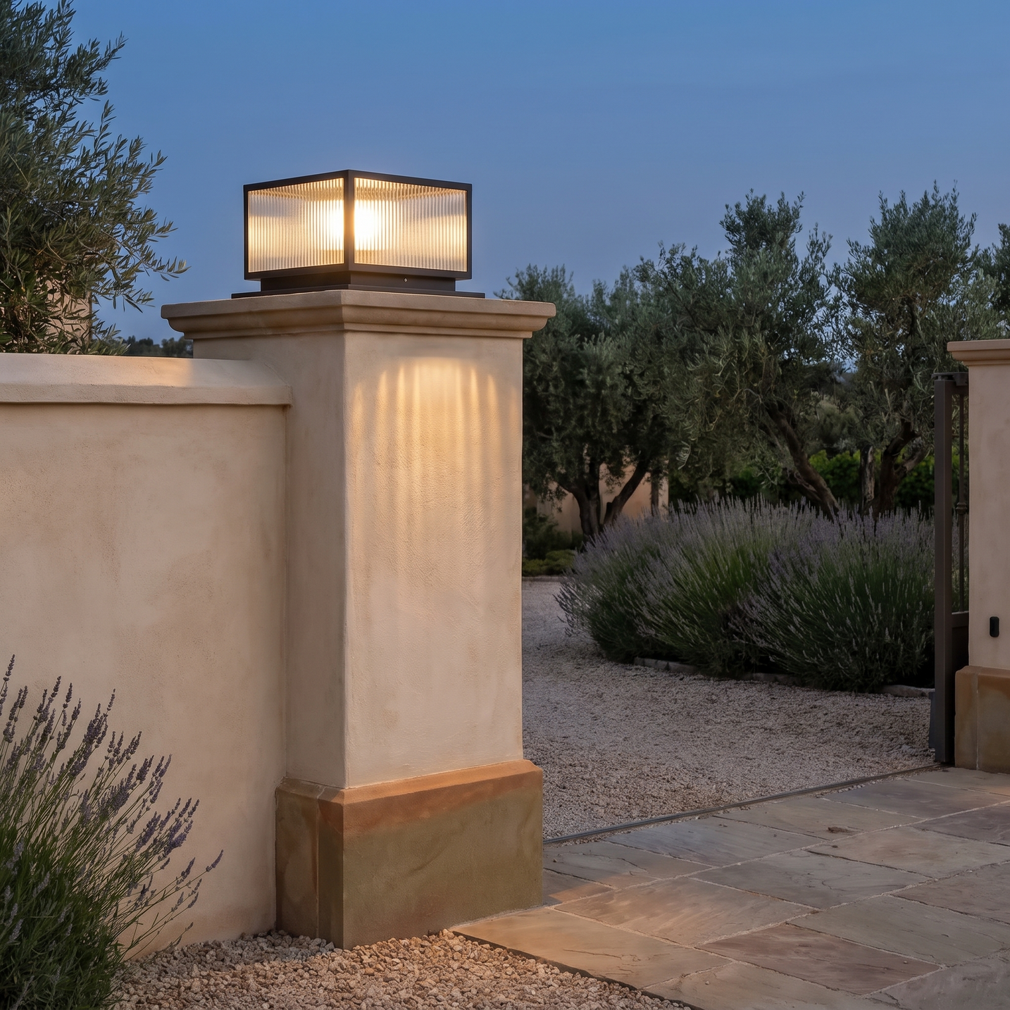 Rialto pillar light capping a rendered stone gate pier at dusk