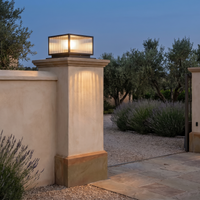 Rialto pillar light capping a rendered stone gate pier at dusk