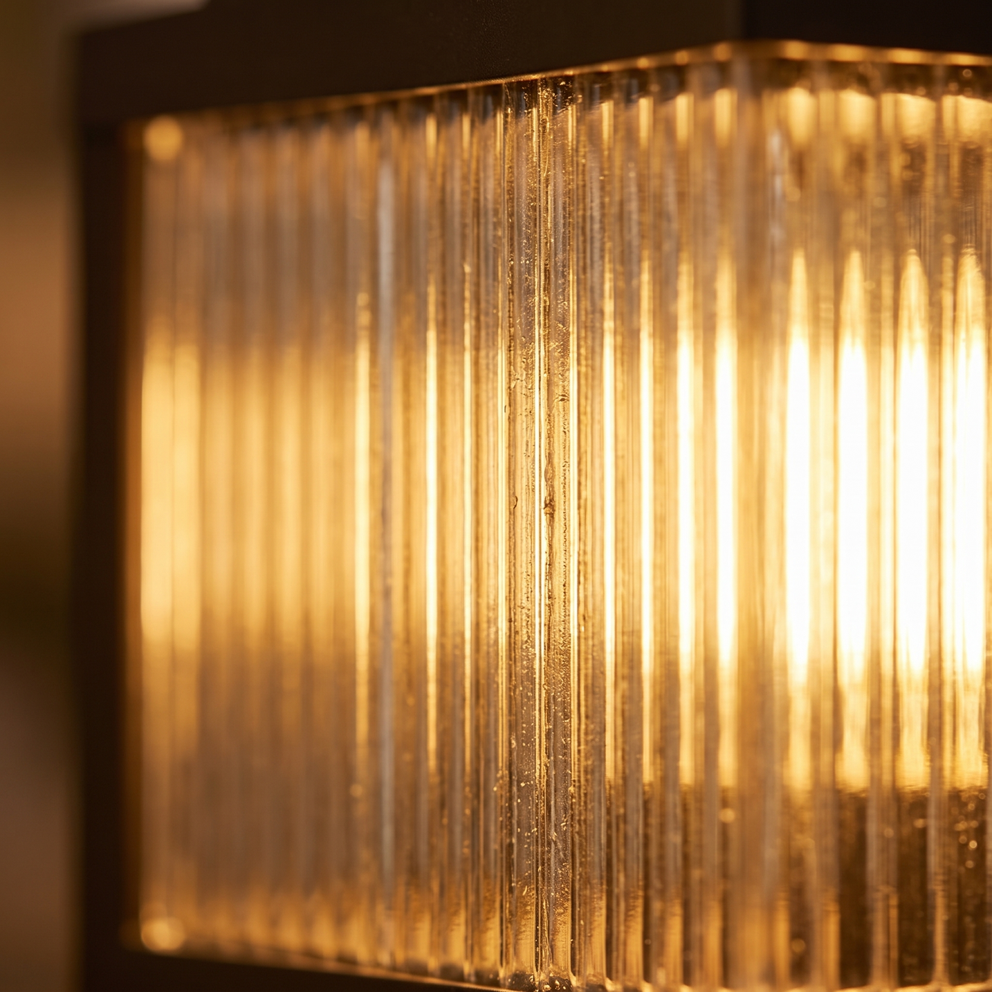Macro detail of the vertical ribbed glass flutes lit from within on the Rialto pillar light