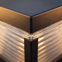 Macro detail of the brushed stainless steel cap and mitred corner joint on the Rialto pillar light
