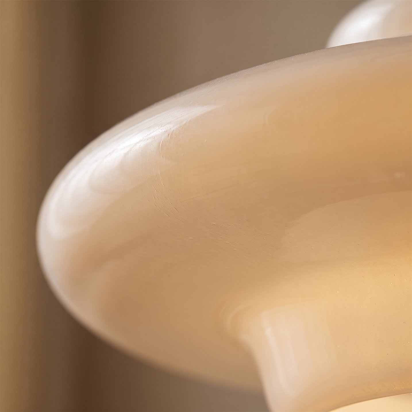 Macro detail of the hand blown opalescent glass surface on the Lattea pendant light