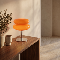 Bellona glass table lamp on a walnut console table in a warm living room