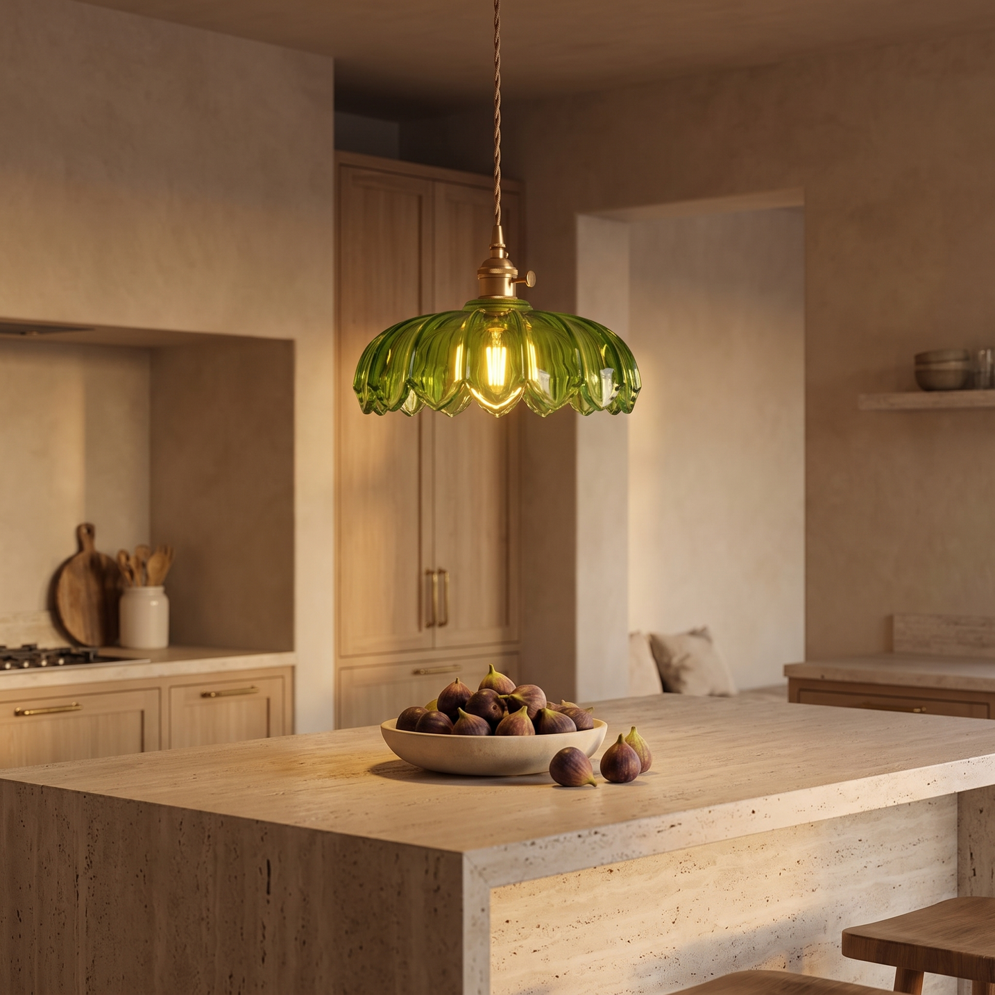 Fiora green glass flower pendant hanging above a travertine kitchen island