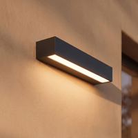 Faro linear porch light on a plaster wall emitting one continuous stripe of warm light